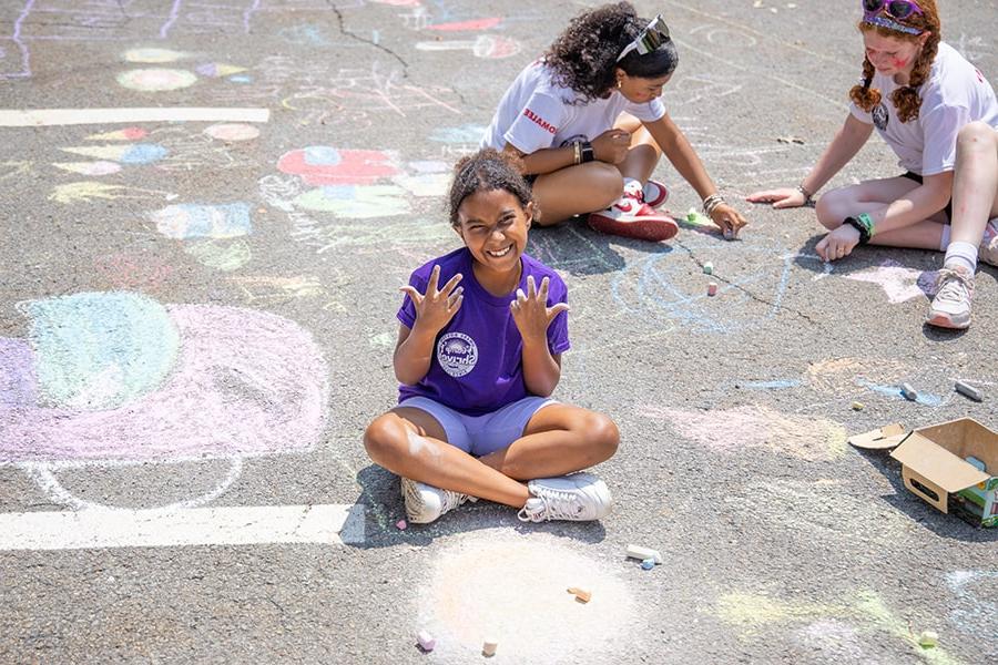 Camp Shriver girl with chalk sidewalk